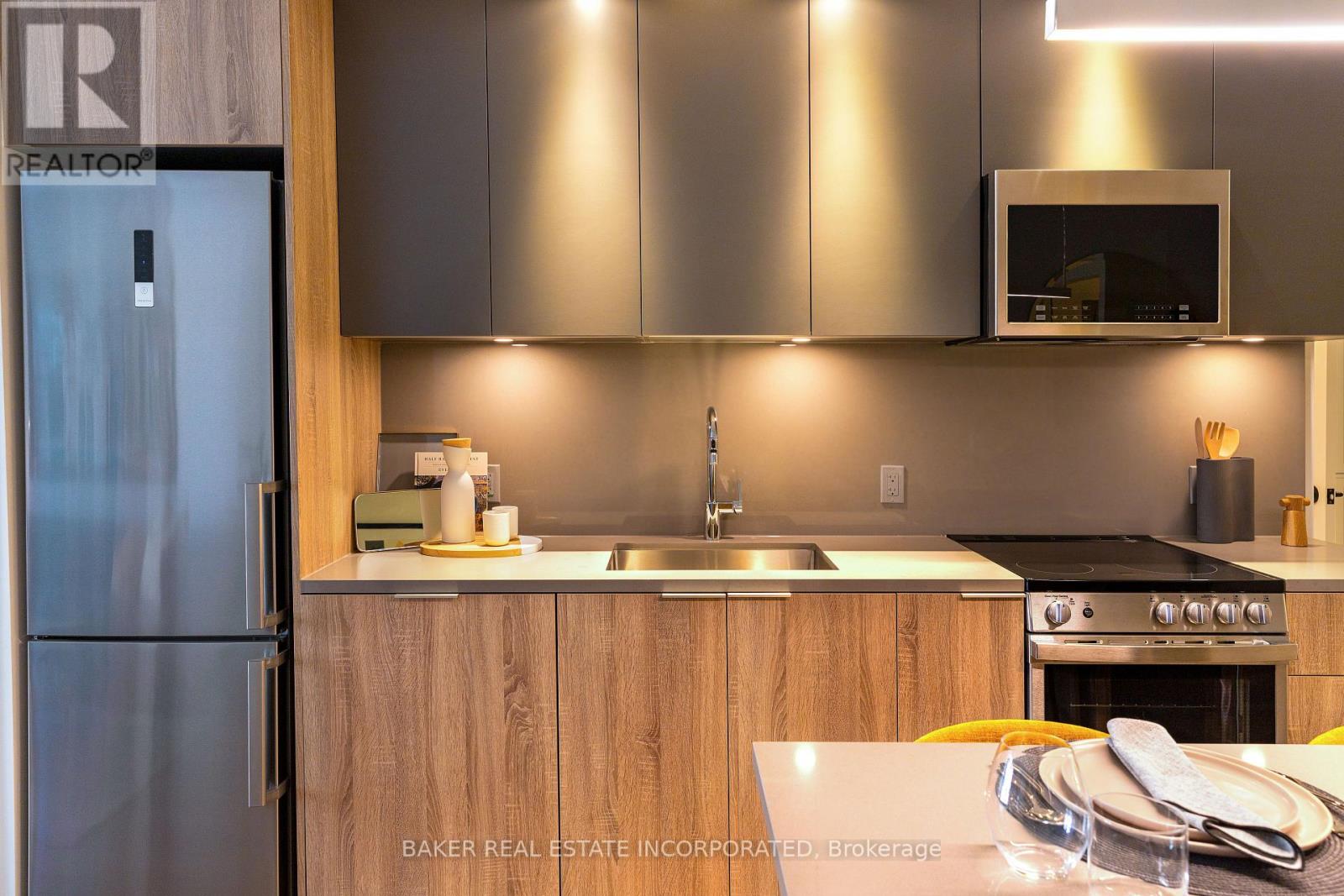 A modern kitchen with a refrigerator and a sink.