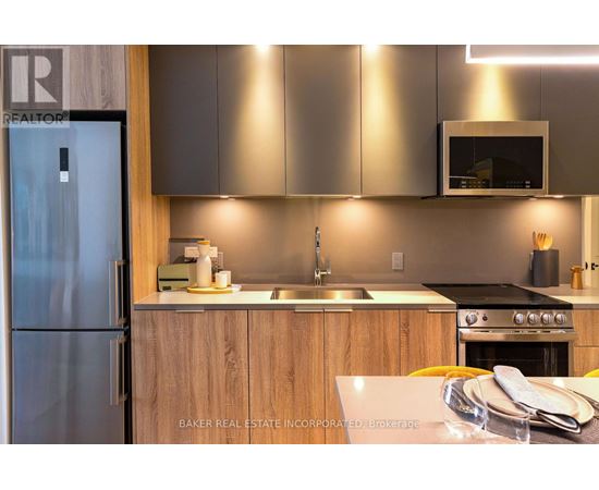 A modern kitchen with a refrigerator and a sink.