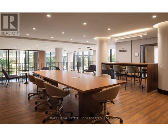 A conference room with a long table and chairs, and a sign that reads "REALTOR".