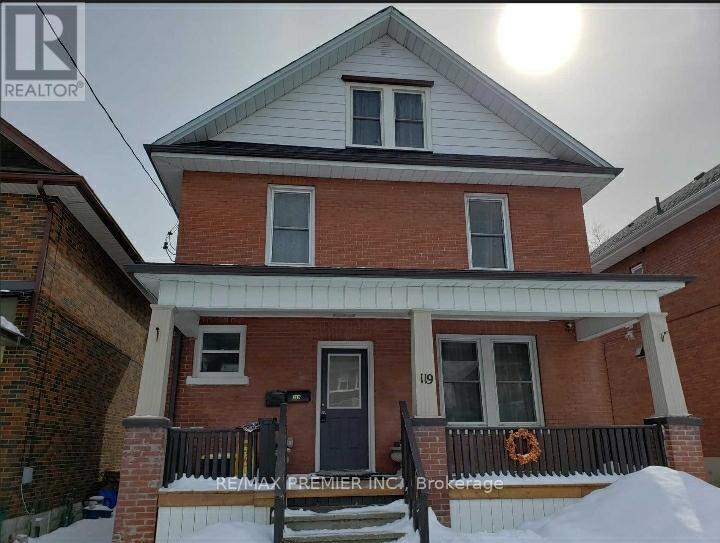A house with a black door and a sign that says RE/MAX Premier Realty.