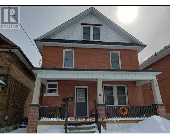 A house with a black door and a sign that says RE/MAX Premier Realty.