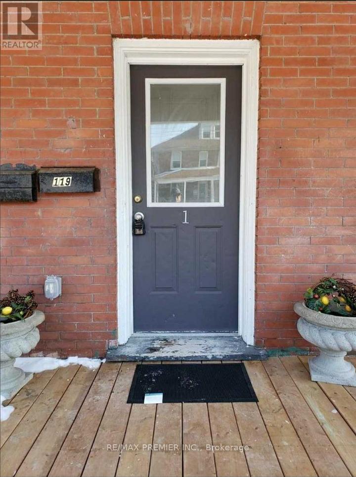 A blue door with a mailbox on the brick wall.