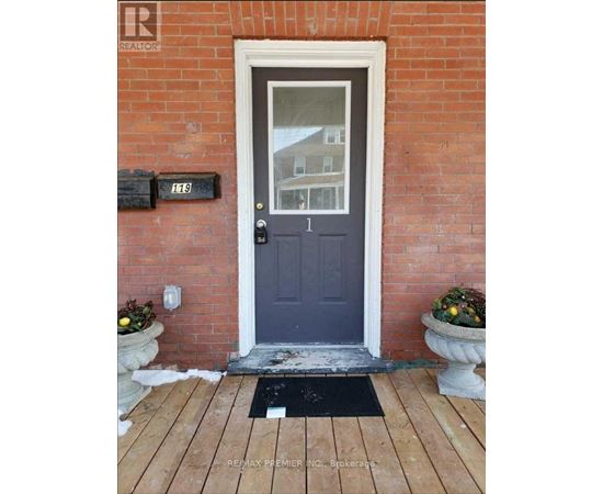 A blue door with a mailbox on the brick wall.