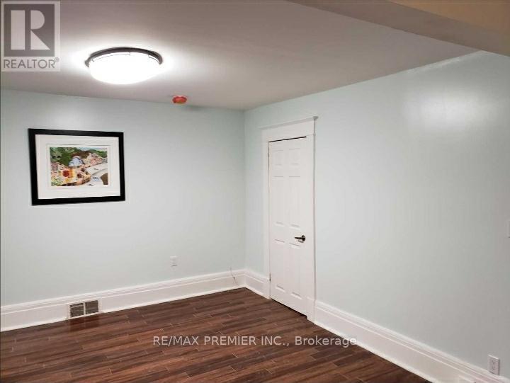 A room with a white door and a picture on the wall.