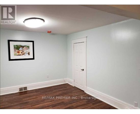 A room with a white door and a picture on the wall.