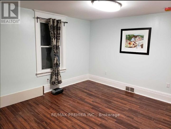 A room with a window and a picture on the wall.