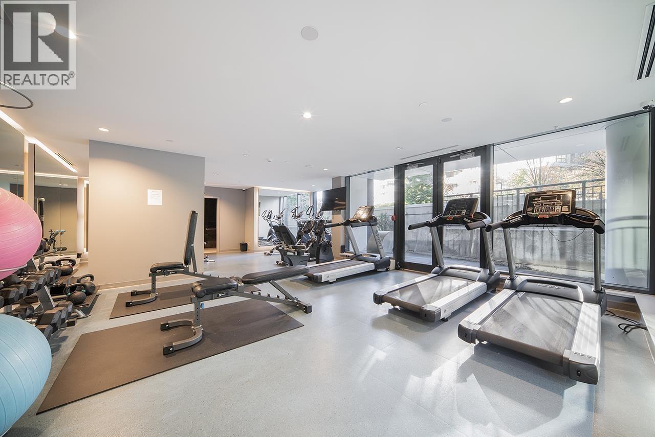 A gym with treadmills, exercise balls, and weights.