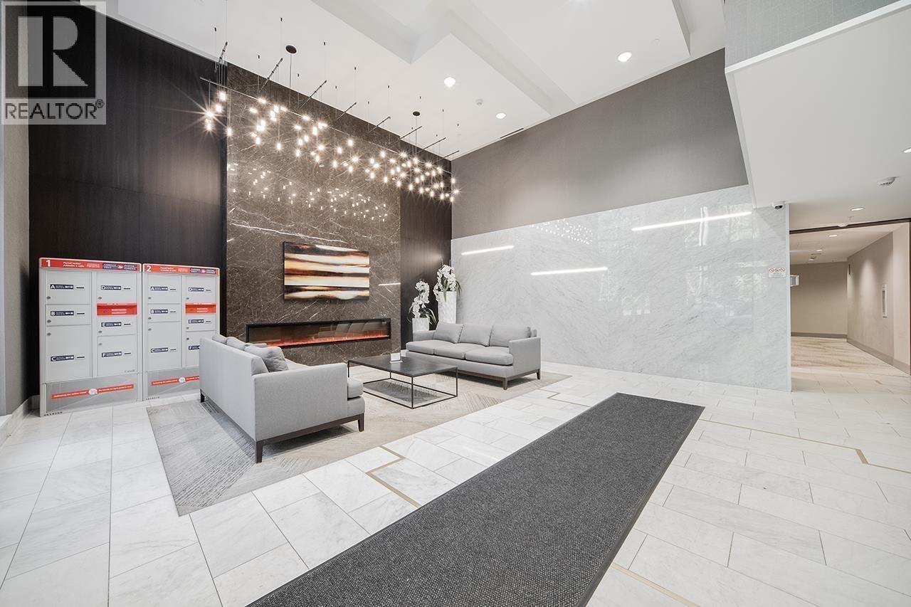 A modern living room with a grey sofa and a fireplace.