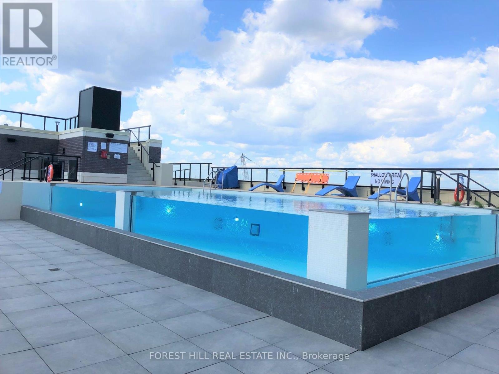 A pool with a slide and a hot tub on the roof.