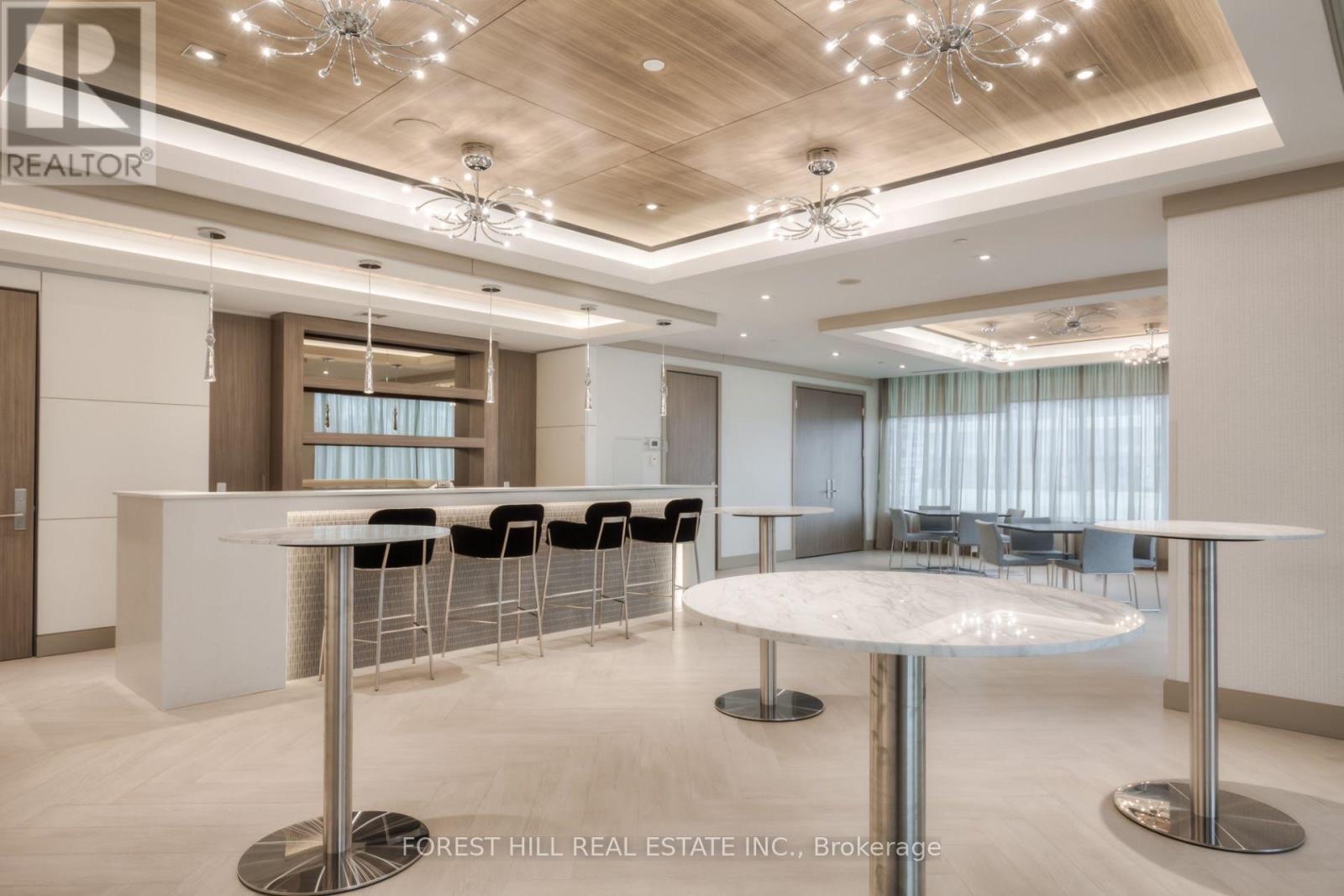 A modern dining room with a white table and chairs.