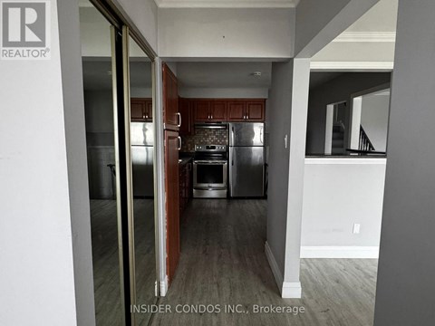 A kitchen with a refrigerator, oven, and sink is shown in a real estate listing.