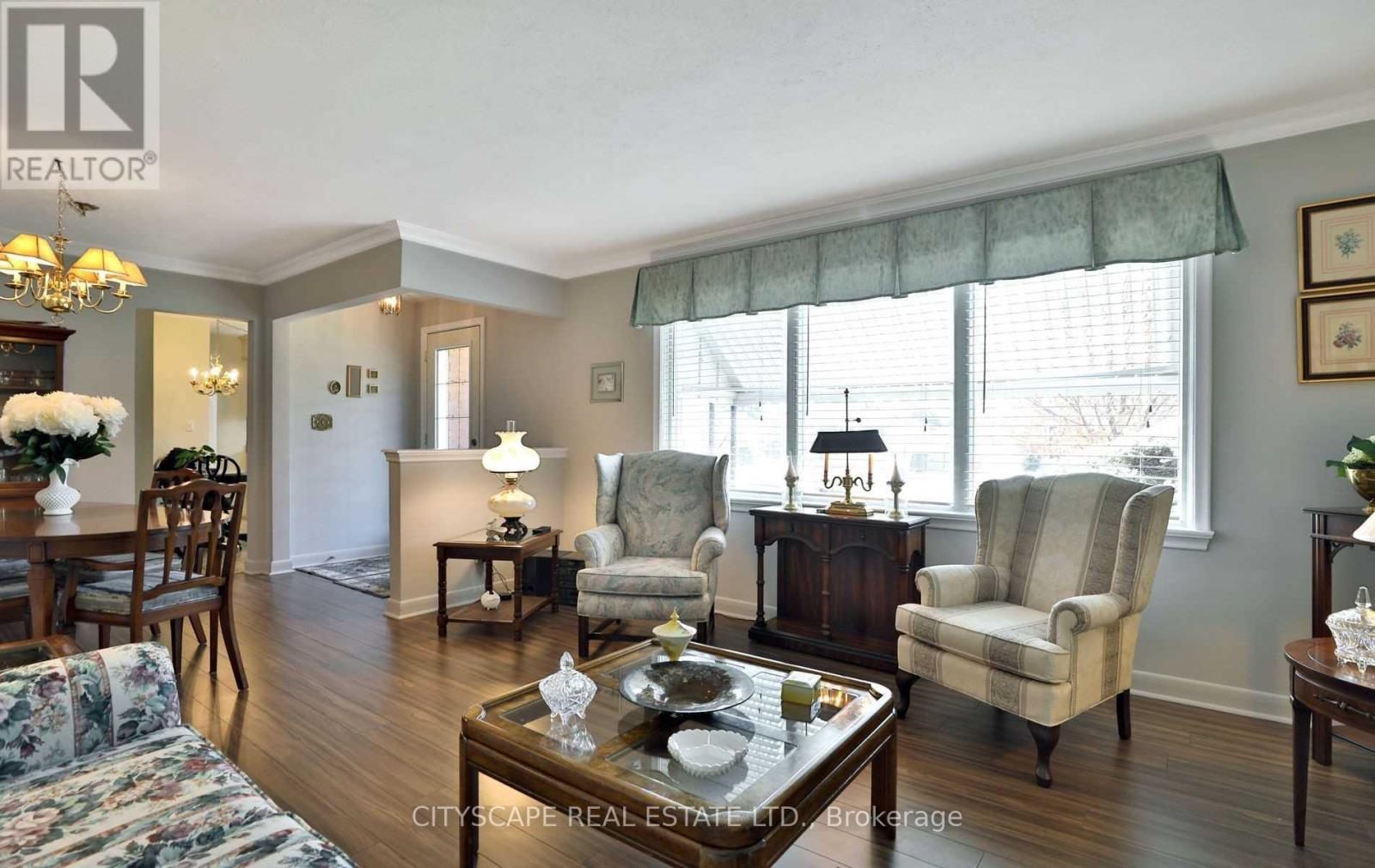 A well-lit living room with a dining table and chairs.