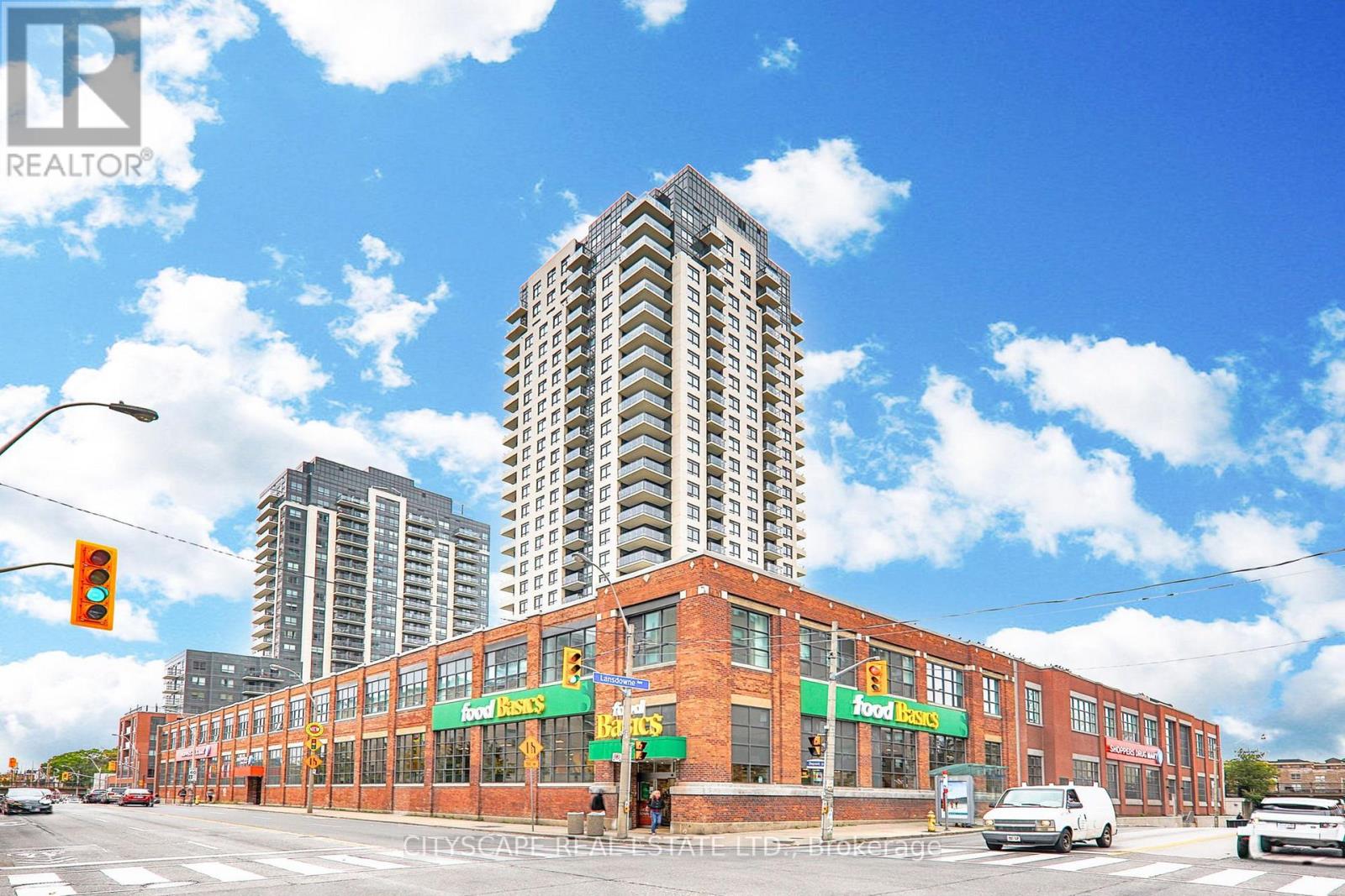 A street view with a Food Banks building in the foreground and a tall building in the background.