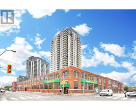 A street view with a Food Banks building in the foreground and a tall building in the background.