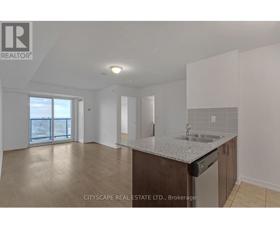 A kitchen area with a sink and a dishwasher.