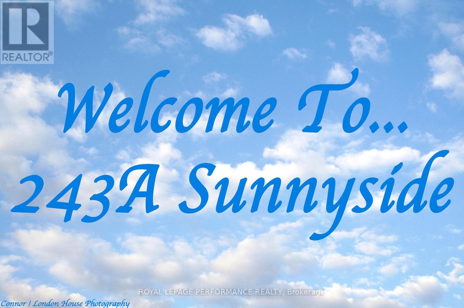 A real estate advertisement with a blue sky and clouds in the background.
