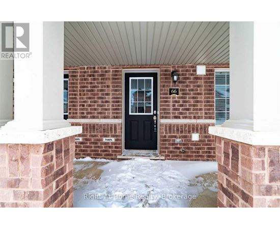 A black door is on the brick house.