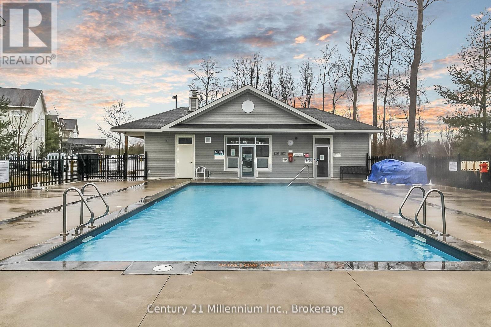 A pool in front of a house with a sign that says Century 21 Millennium Inc., Brokerage.