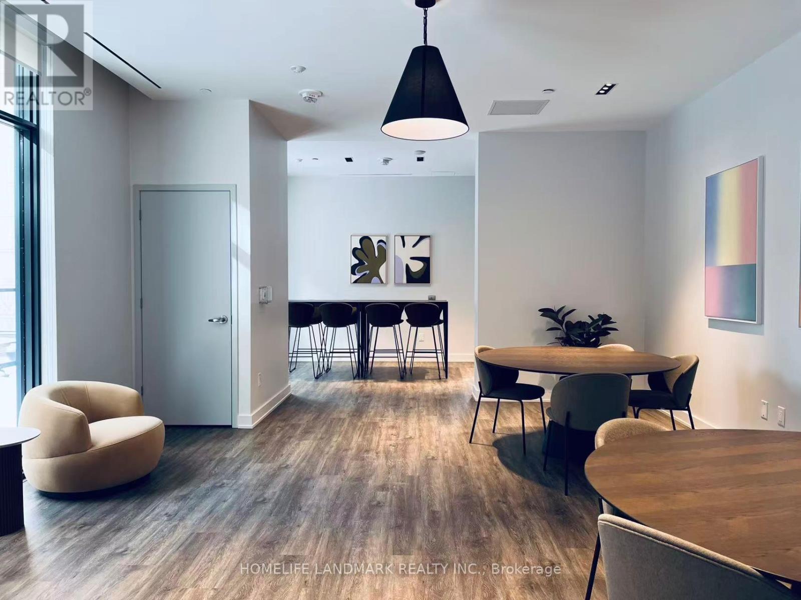 A modern dining room with a wooden table and chairs.