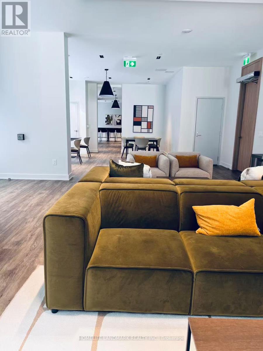 A living room with a green couch and a white wall.