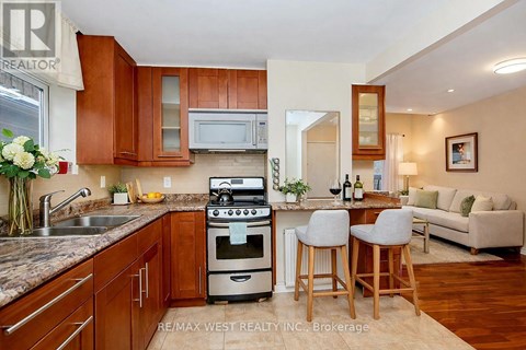 A kitchen with wooden cabinets and a stove top oven.