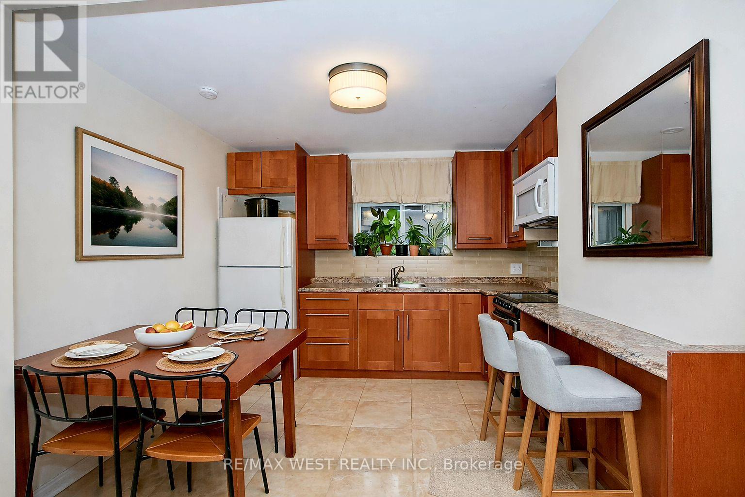 A kitchen with a table set for four with a view of a lake.