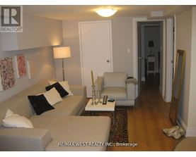 A living room with a couch, chair, and lamp.