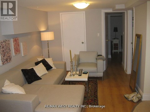 A living room with a couch, chair, and lamp.