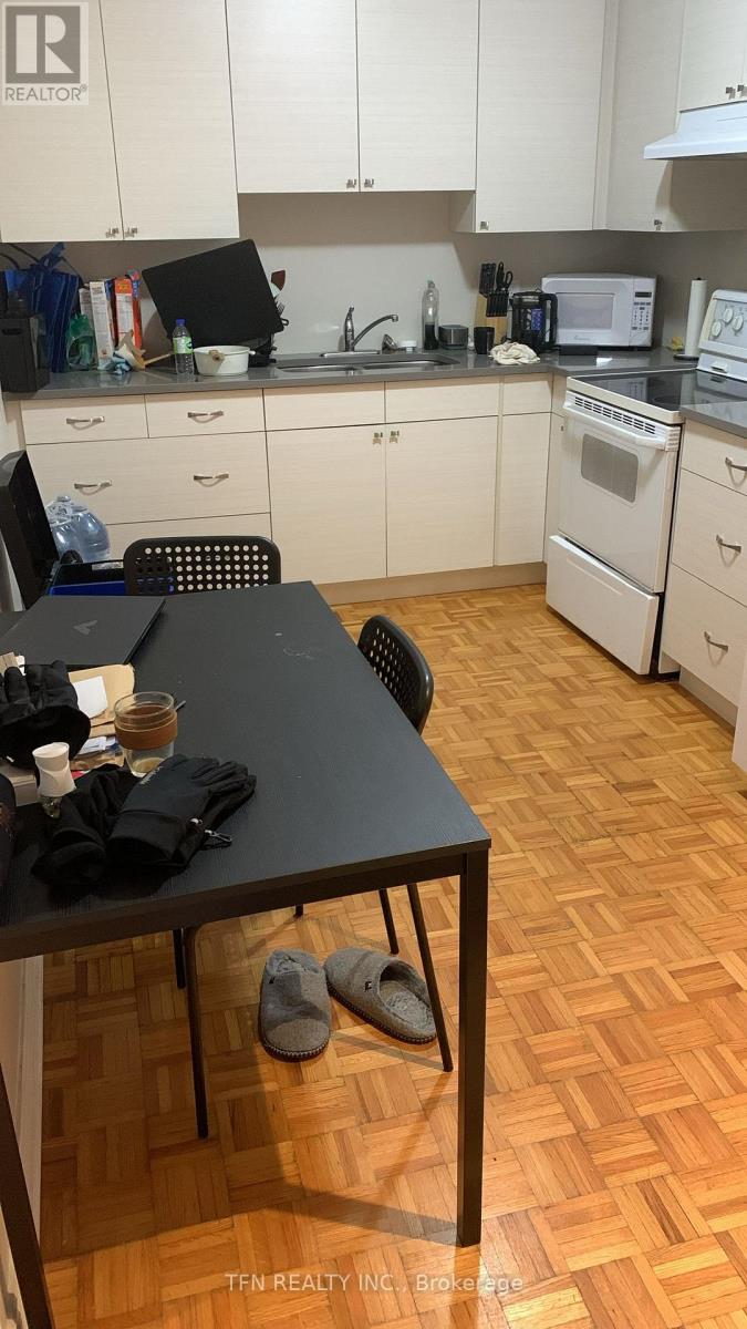 A kitchen with a table and chairs in it.