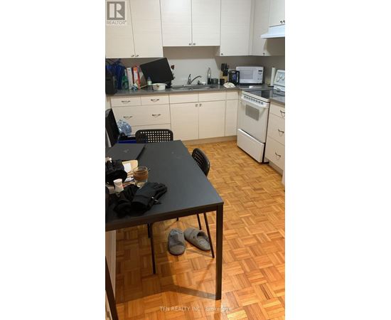 A kitchen with a table and chairs in it.
