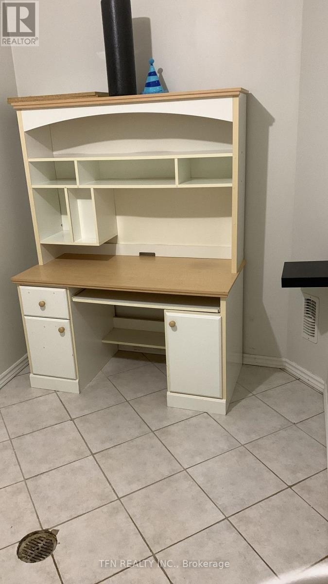 A white desk with drawers underneath it.