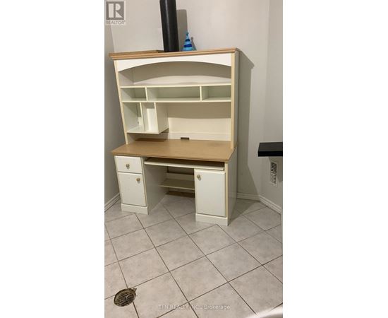 A white desk with drawers underneath it.
