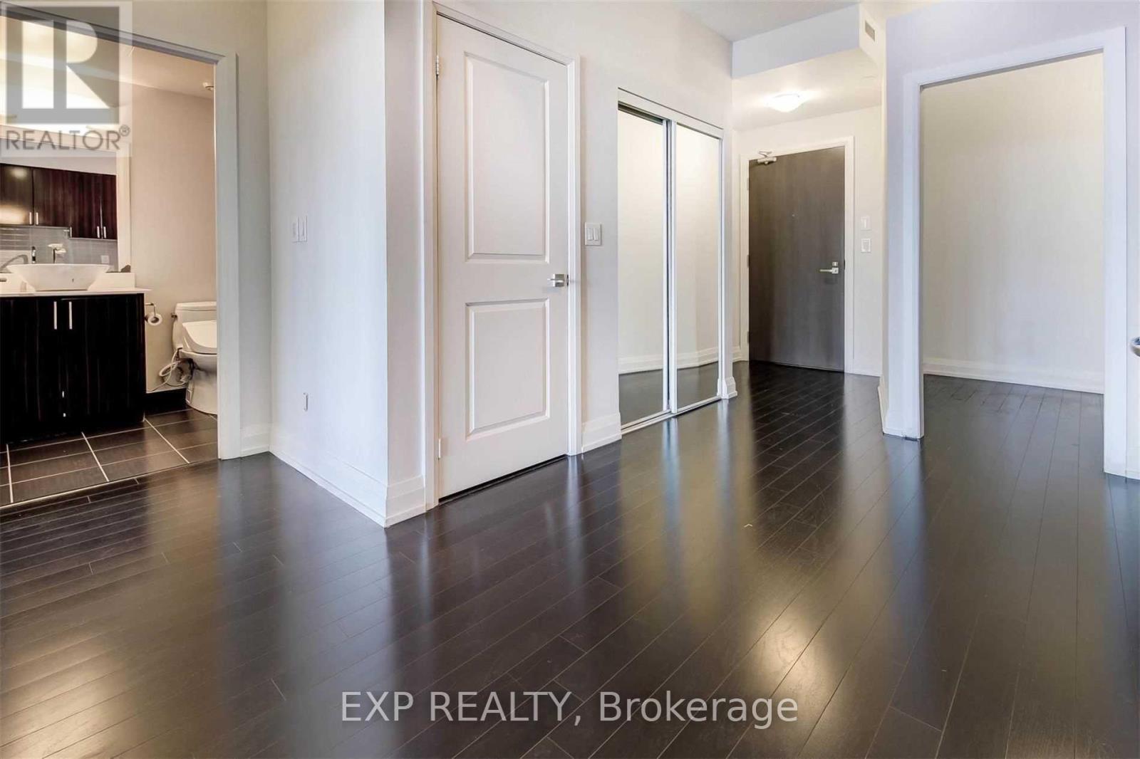 A room with wooden floors and white walls.