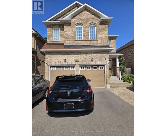 A black sports car is parked in front of a two-story house.