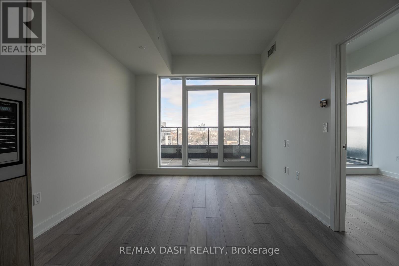 A spacious room with a view of the city through the windows.