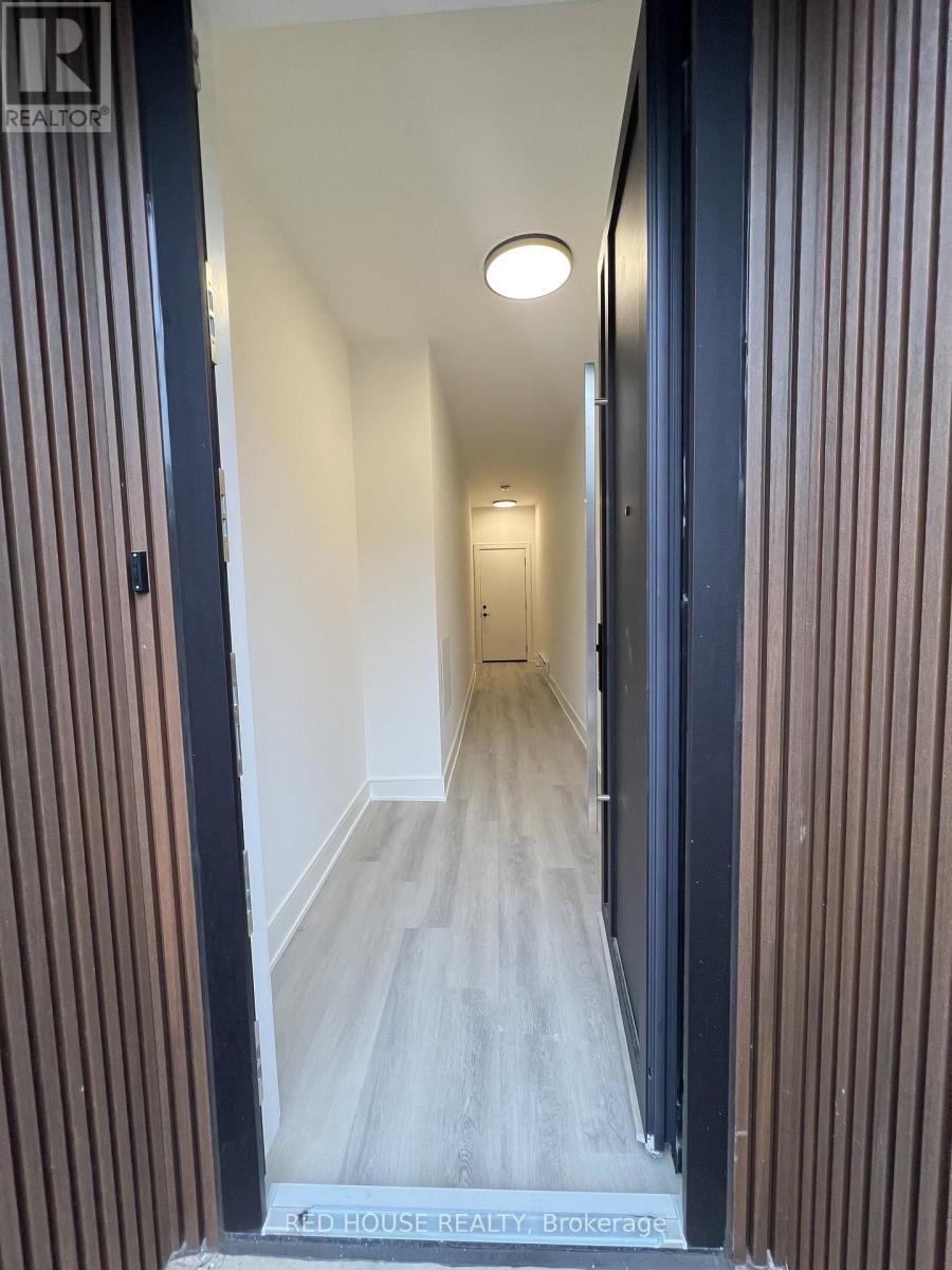 A hallway with a wooden floor and striped walls.