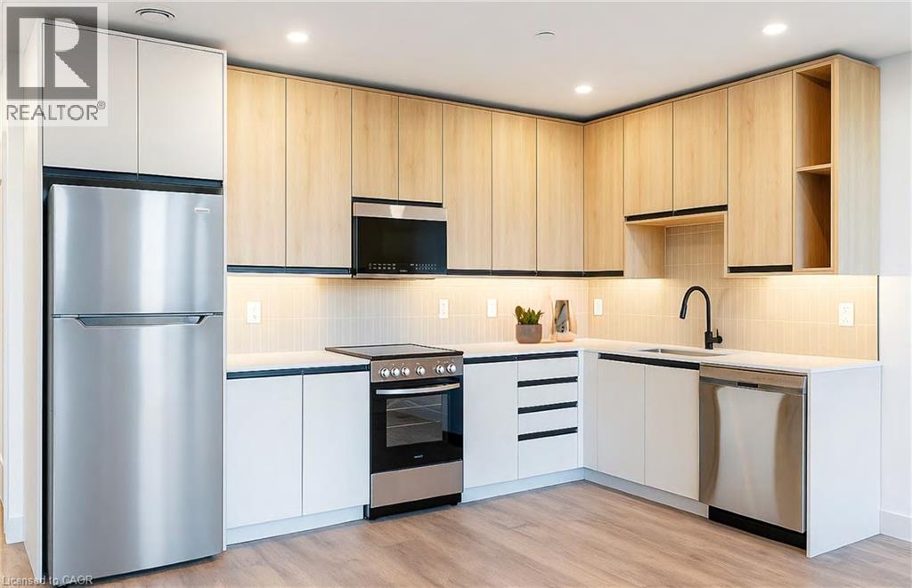 A modern kitchen with wooden cabinets and stainless steel appliances.