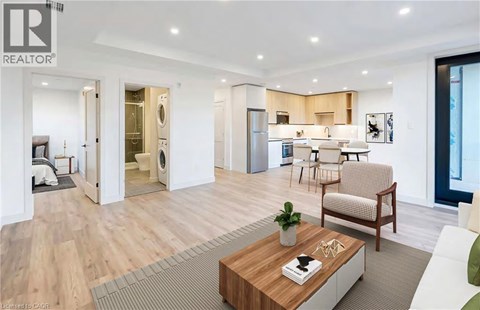 A modern living room with a wooden floor and a coffee table in the center.