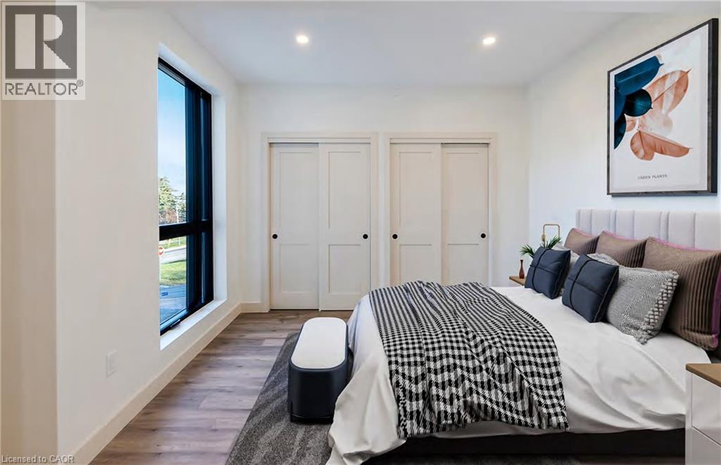 A bedroom with a bed, pillows, and a painting on the wall.