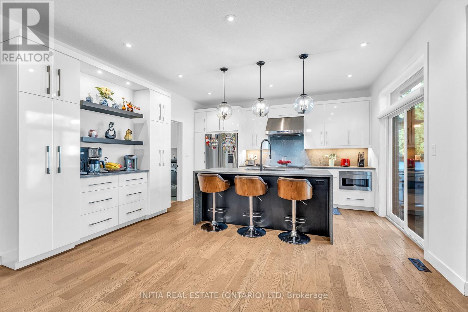 A modern kitchen with white cabinets and a central island.