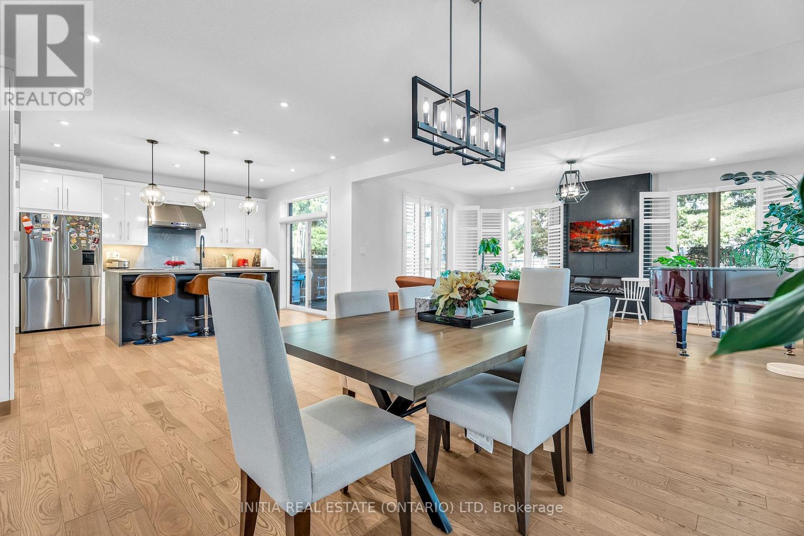 A modern dining room with a large table and chairs.