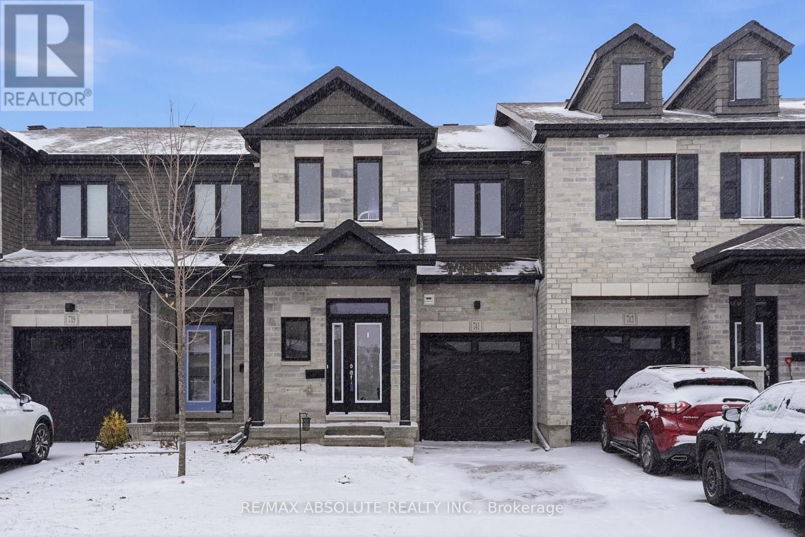 A large house with a car parked in front of it.