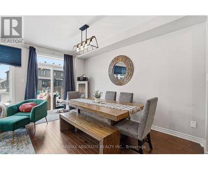 A dining room with a wooden table and chairs.