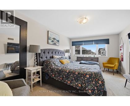 A bedroom with a large bed and a yellow chair.