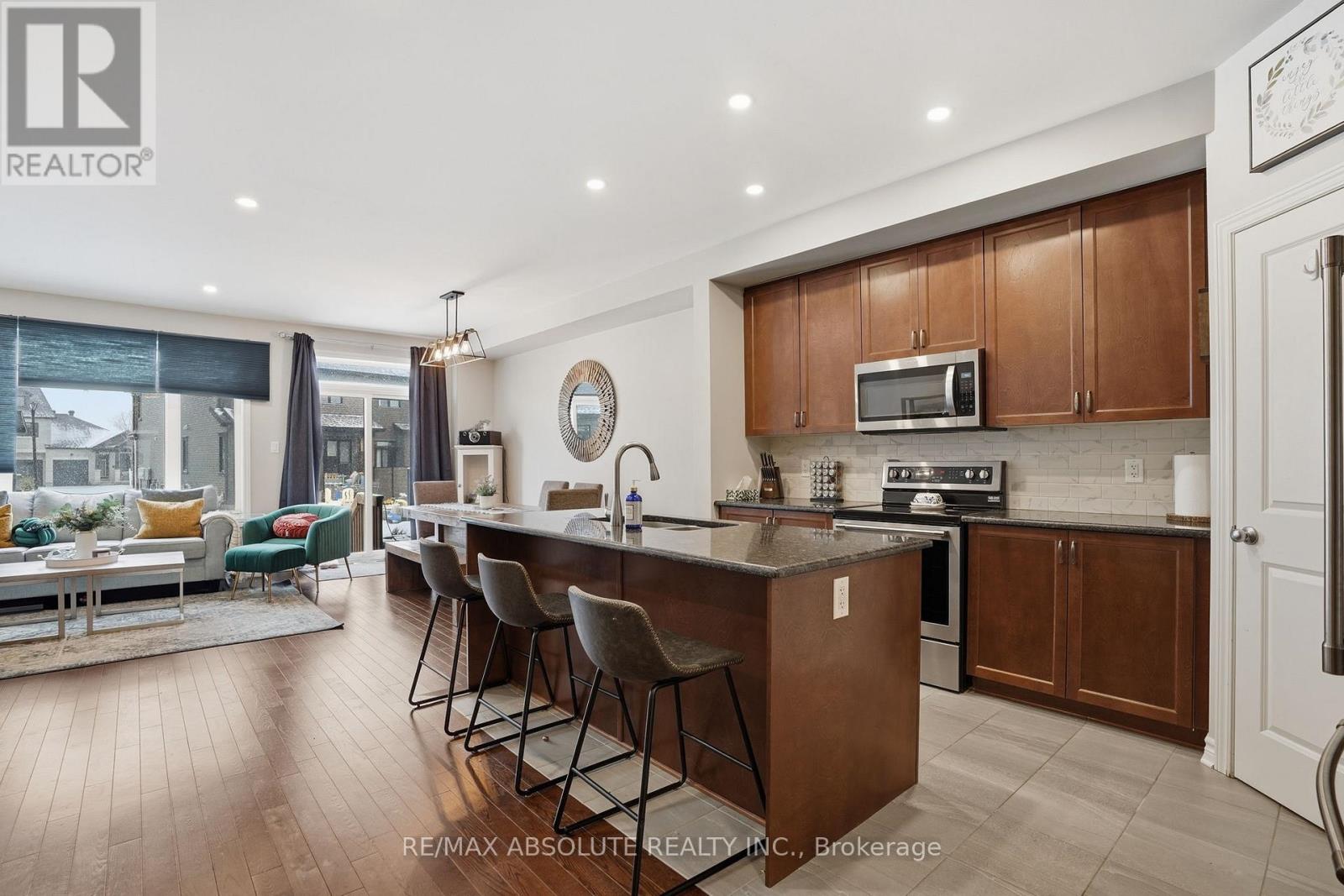 A modern kitchen with wooden cabinets and a large island.