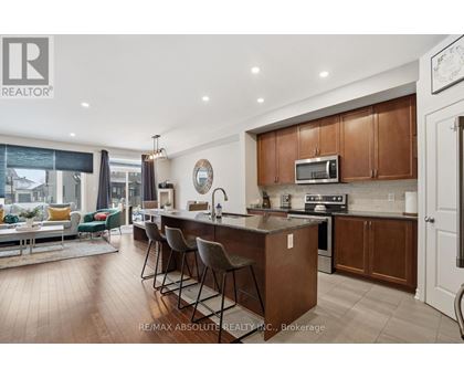 A modern kitchen with wooden cabinets and a large island.