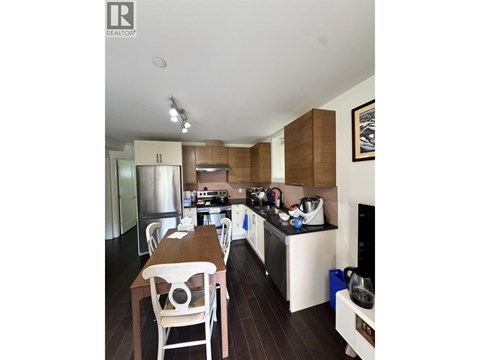 A kitchen with a table and chairs in the middle of it.