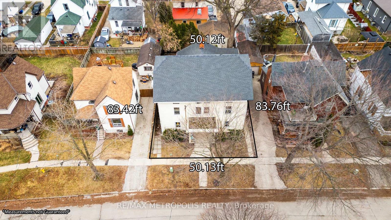 An aerial view of a residential area with houses and a road.