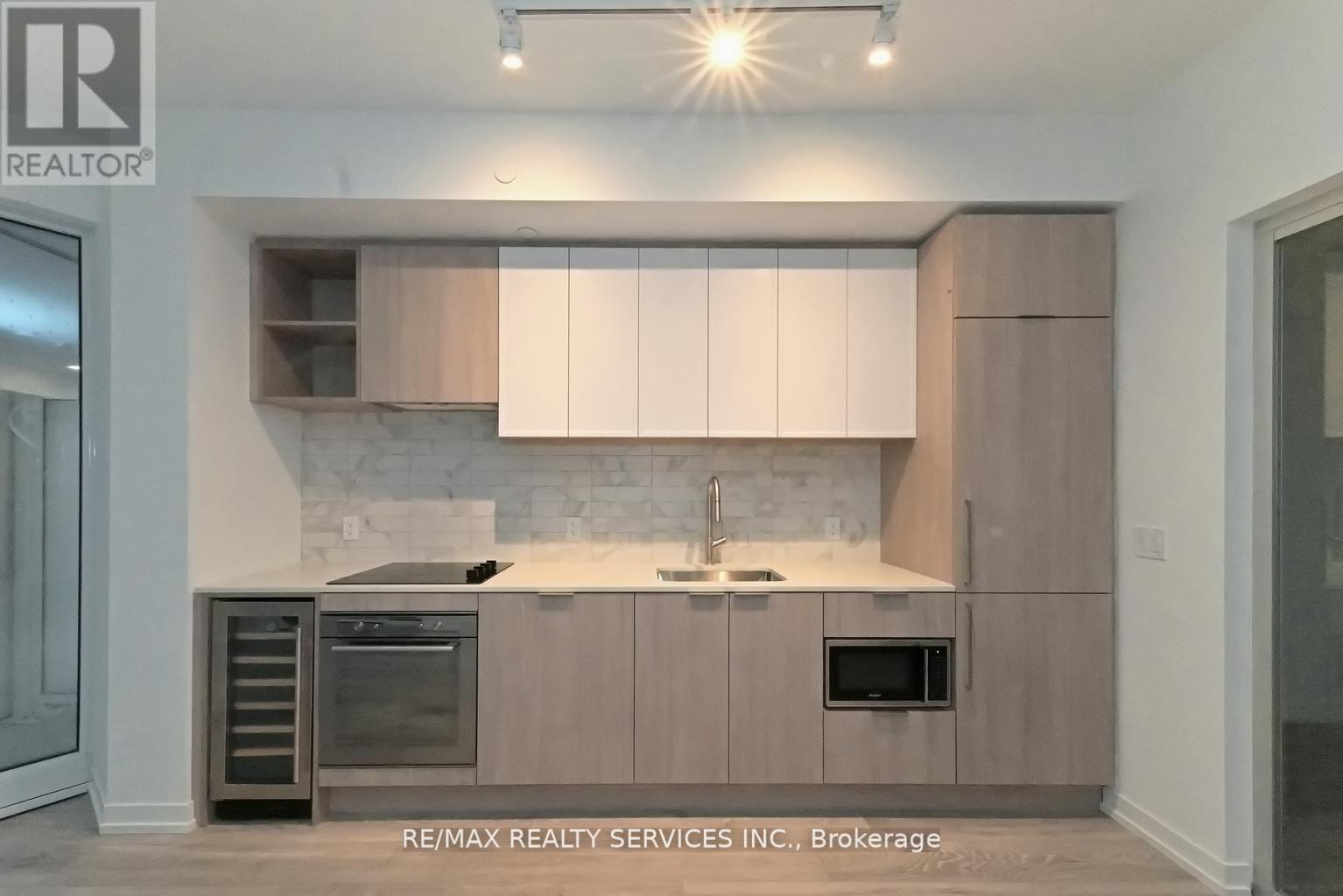 A modern kitchen with a sink and oven.