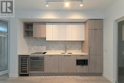 A modern kitchen with a sink and oven.
